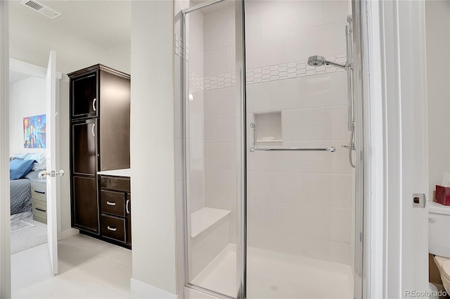 bathroom with visible vents, a shower stall, ensuite bathroom, tile patterned floors, and toilet