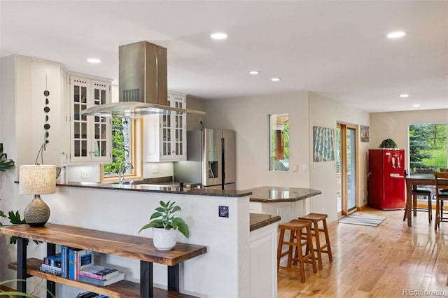 4230 S Meadow Brook Ln, Evergreen, CO 80439 - kitchen featuring stainless steel fridge with ice dispenser, recessed lighting, glass insert cabinets, white cabinets, and a kitchen bar