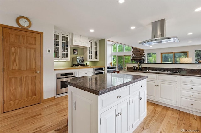 4230 S Meadow Brook Ln, Evergreen, CO 80439 - kitchen with oven, light wood-style floors, island range hood, a center island, and recessed lighting