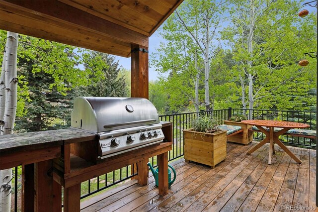 4230 S Meadow Brook Ln, Evergreen, CO 80439 - wooden terrace featuring grilling area and view of wooded area