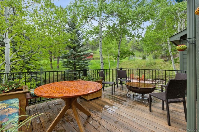 4230 S Meadow Brook Ln, Evergreen, CO 80439 - wooden terrace featuring view of wooded area
