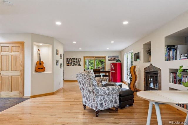 4230 S Meadow Brook Ln, Evergreen, CO 80439 - living area with light wood-type flooring, a glass covered fireplace, recessed lighting, and baseboards