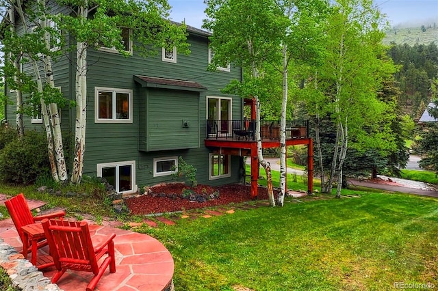 4230 S Meadow Brook Ln, Evergreen, CO 80439 - back of property featuring a lawn and a deck