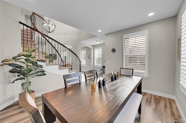 dining area featuring an inviting chandelier and light wood-type flooring