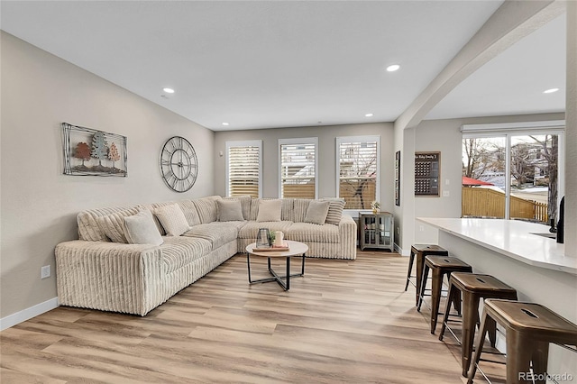 living room featuring plenty of natural light and light hardwood / wood-style flooring