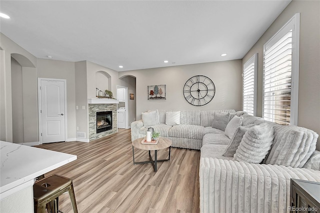 living room featuring a fireplace and light hardwood / wood-style floors