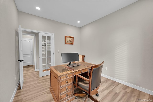 office area with light hardwood / wood-style flooring and french doors