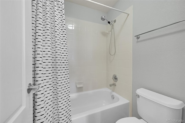 bathroom with tiled shower / bath and toilet