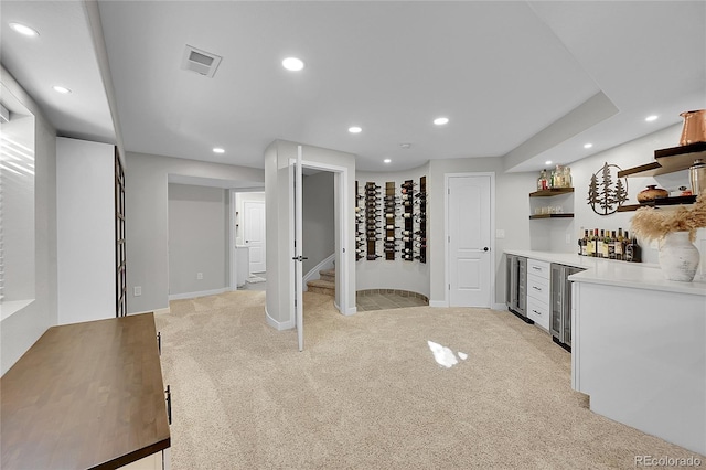 kitchen featuring light carpet and beverage cooler