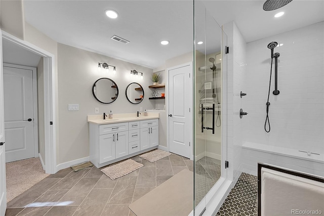 bathroom with vanity and a tile shower