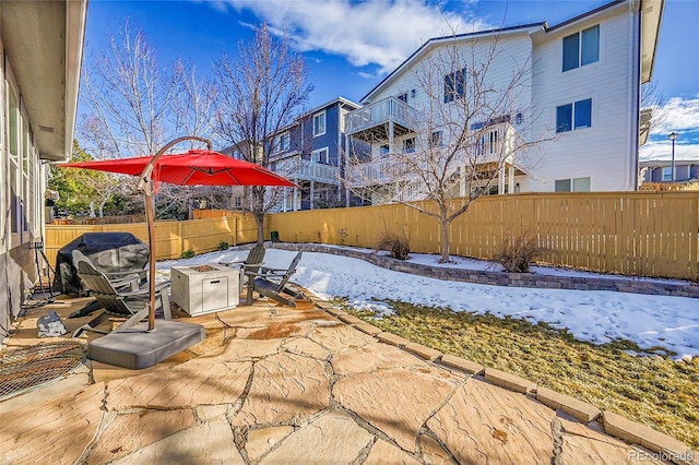 snow covered patio featuring an outdoor fire pit