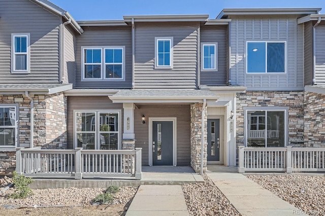 1986 S Haleyville Way, Aurora, CO 80018 - townhome / multi-family property with stone siding and a porch