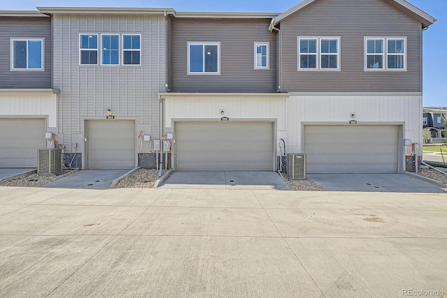 1986 S Haleyville Way, Aurora, CO 80018 - townhome / multi-family property featuring central air condition unit, a garage, and concrete driveway
