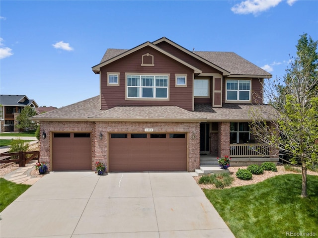 1852 E Sea Drift Dr, Windsor, CO 80550 - craftsman-style house with a shingled roof, brick siding, concrete driveway, and a porch