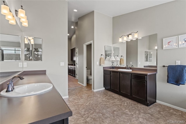 1852 E Sea Drift Dr, Windsor, CO 80550 - bathroom with two vanities, a chandelier, high vaulted ceiling, and recessed lighting