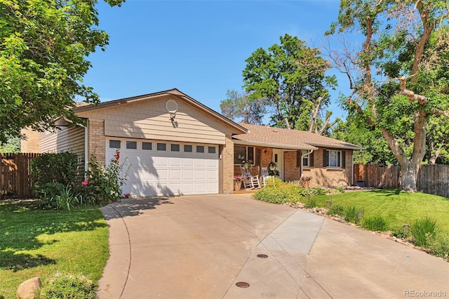 8262 Otis Ct, Arvada, CO 80003 - single story home featuring a garage, driveway, brick siding, and covered porch