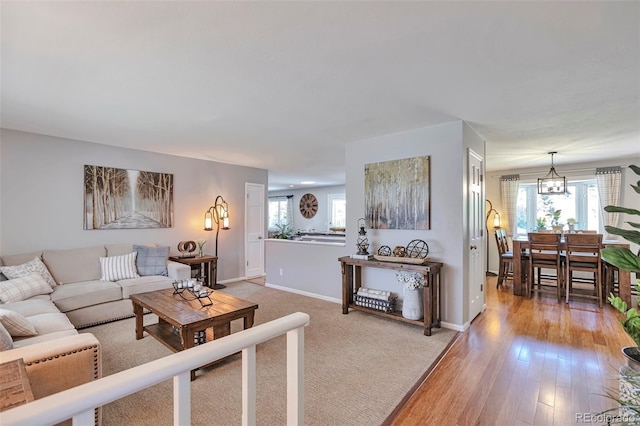 8262 Otis Ct, Arvada, CO 80003 - living area featuring a chandelier and light wood finished floors
