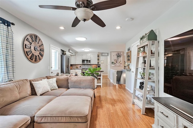 8262 Otis Ct, Arvada, CO 80003 - living room with light wood-style floors, ceiling fan, and recessed lighting