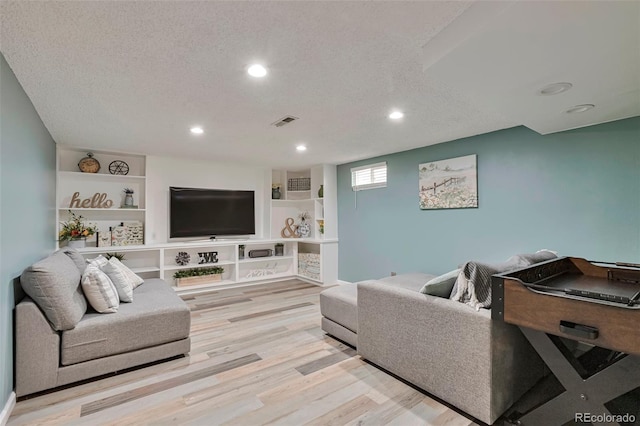 8262 Otis Ct, Arvada, CO 80003 - living area featuring wood finished floors, recessed lighting, and a textured ceiling