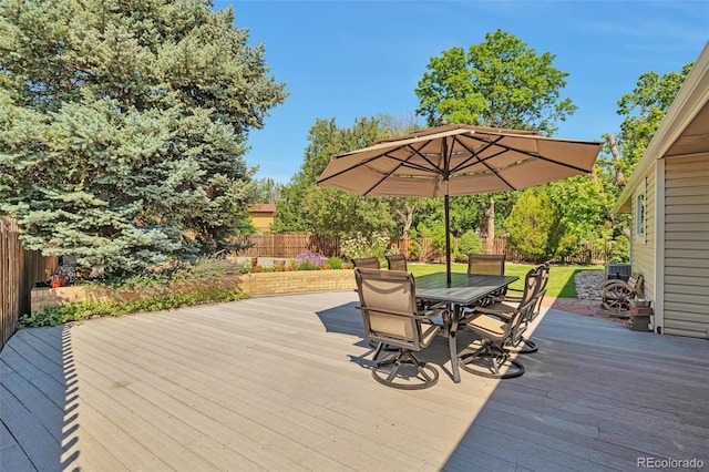 8262 Otis Ct, Arvada, CO 80003 - wooden deck featuring a fenced backyard and outdoor dining space