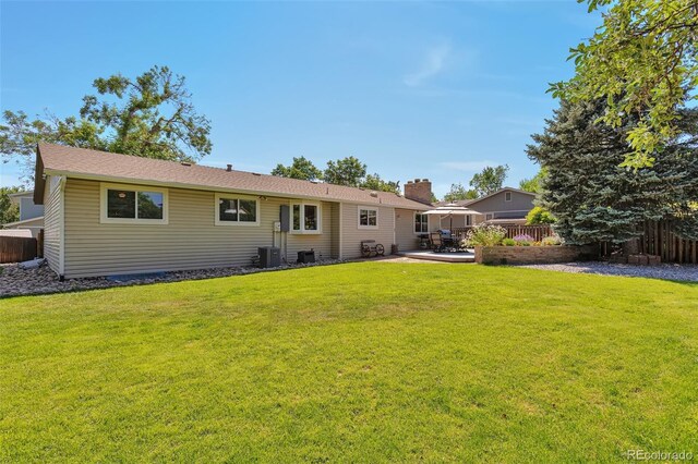 8262 Otis Ct, Arvada, CO 80003 - rear view of property with a chimney and a patio area