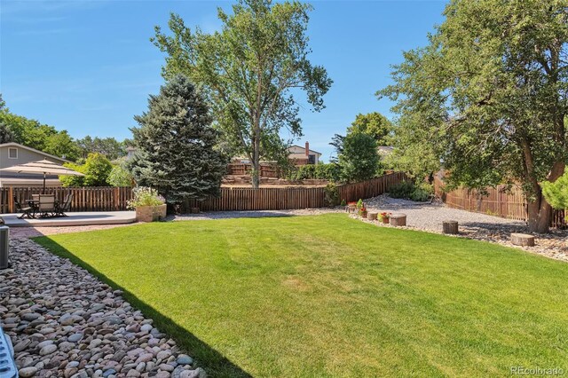 8262 Otis Ct, Arvada, CO 80003 - fenced backyard featuring a patio area