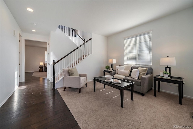 living area featuring stairs, recessed lighting, hardwood / wood-style flooring, and baseboards