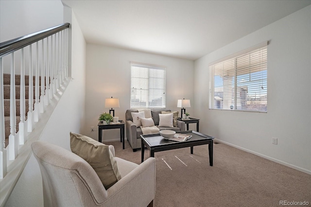 living room featuring carpet floors, stairway, and baseboards