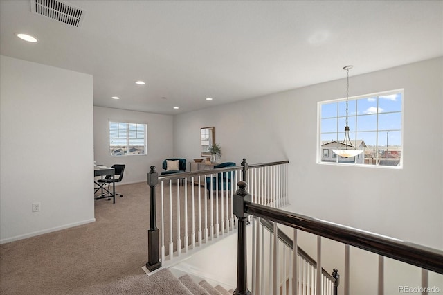 hallway featuring recessed lighting, carpet floors, visible vents, an upstairs landing, and baseboards