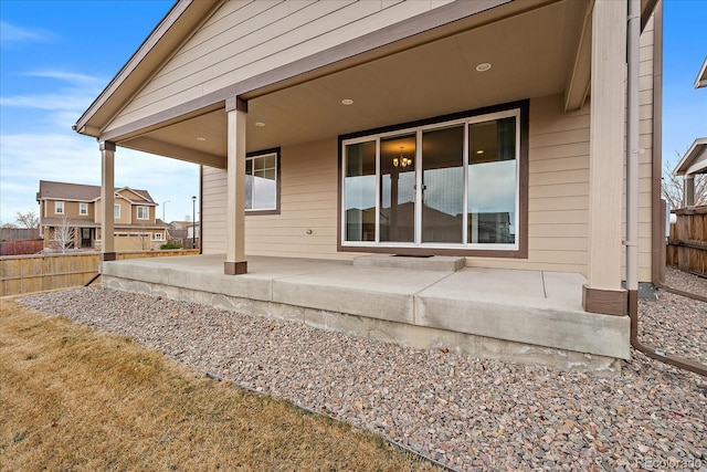 back of property featuring a patio area and fence