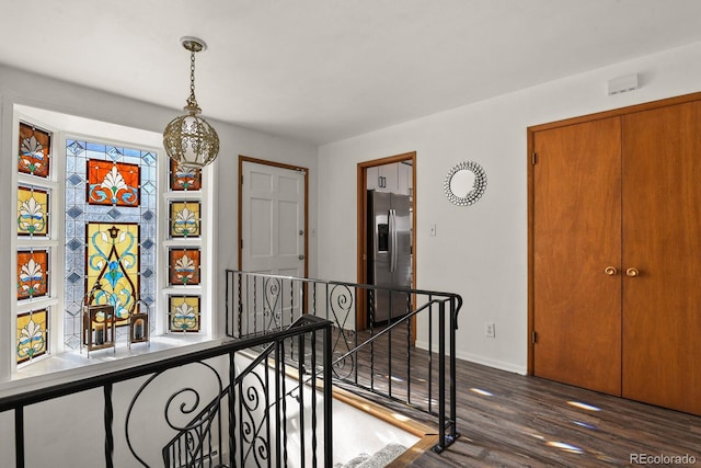 295 E Amherst Ave, Englewood, CO 80113 - hallway with an upstairs landing, dark wood-style flooring, and baseboards