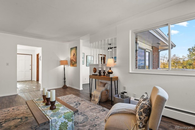 295 E Amherst Ave, Englewood, CO 80113 - living room featuring baseboard heating, wood finished floors, and baseboards