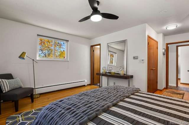 295 E Amherst Ave, Englewood, CO 80113 - bedroom featuring a baseboard heating unit, light wood finished floors, and ceiling fan
