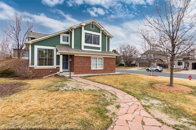 view of side of property with a yard and brick siding