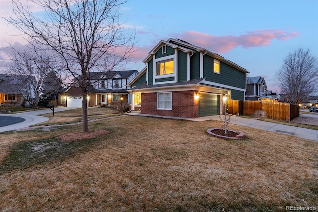 traditional home with fence, concrete driveway, a front yard, brick siding, and solar panels