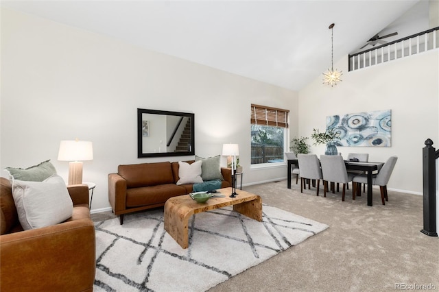 living area with baseboards, carpet floors, and high vaulted ceiling