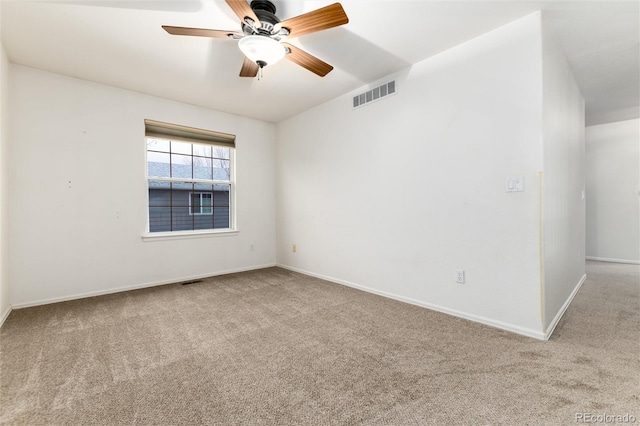 unfurnished room featuring carpet flooring, baseboards, visible vents, and ceiling fan