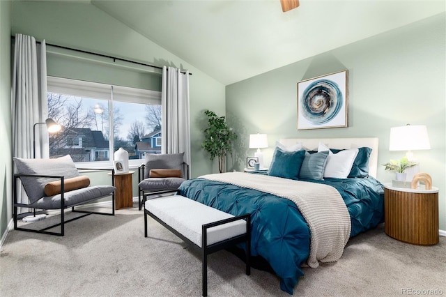 bedroom featuring lofted ceiling and carpet