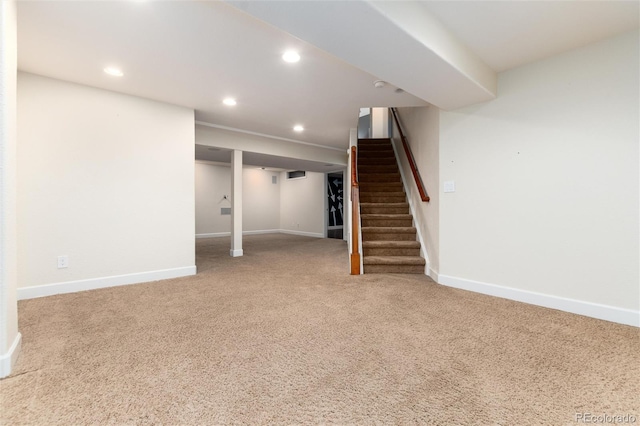 finished below grade area with carpet flooring, recessed lighting, stairs, and baseboards