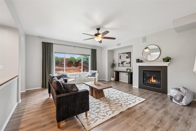 6723 Silverwind Cir, Colorado Springs, CO 80923 - living area featuring ceiling fan, wood finished floors, and a tile fireplace