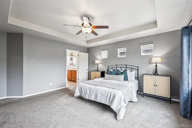 6723 Silverwind Cir, Colorado Springs, CO 80923 - carpeted bedroom featuring a raised ceiling, ceiling fan, and ensuite bathroom
