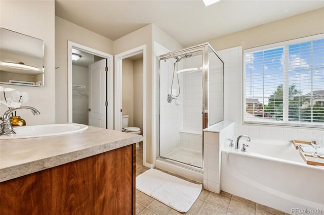 6723 Silverwind Cir, Colorado Springs, CO 80923 - bathroom featuring a shower stall, a garden tub, vanity, and tile patterned flooring