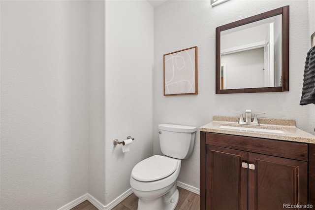 6723 Silverwind Cir, Colorado Springs, CO 80923 - half bath featuring wood finished floors and vanity