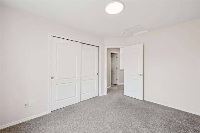 6723 Silverwind Cir, Colorado Springs, CO 80923 - unfurnished bedroom featuring carpet, attic access, and a closet