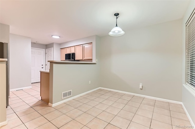 1121 W 112th Ave Unit C, Denver, CO 80234 - kitchen featuring stainless steel microwave, light tile patterned flooring, pendant lighting, a peninsula, and recessed lighting