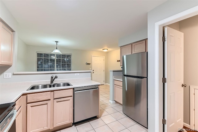 1121 W 112th Ave Unit C, Denver, CO 80234 - kitchen featuring stainless steel appliances, a peninsula, light tile patterned floors, light countertops, and hanging light fixtures
