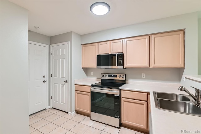 1121 W 112th Ave Unit C, Denver, CO 80234 - kitchen featuring electric range, light brown cabinets, light tile patterned floors, and light countertops