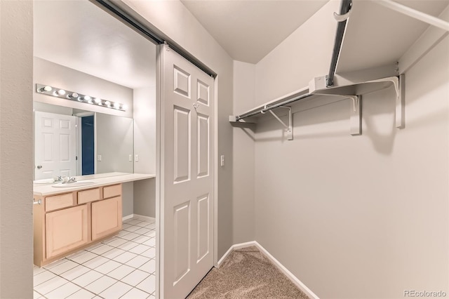 1121 W 112th Ave Unit C, Denver, CO 80234 - walk in closet with light tile patterned floors and a sink