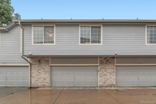 1121 W 112th Ave Unit C, Denver, CO 80234 - view of front facade featuring brick siding and a garage