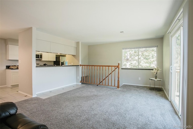 unfurnished living room featuring light carpet